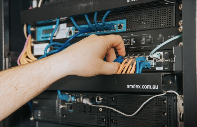 Hand working on data cables